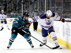 Mikkel Boedker of the San Jose Sharks and Patrick Maroon of the Edmonton Oilers go into the boards for the puck at SAP Center on Dec. 23, 2016. (Getty Images)