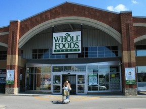 A customer leaves a Whole Foods Market store in Oakville, Ont., Aug.22, 2012. Texas-based Whole Foods Market says it's cancelling plans to open stores in Calgary and Edmonton.The news appears to signal a slowdown in the organic food supermarket chain's plan announced at a Montreal conference two years ago to grow from 10 to 40 stores in Canada. Richard Buchan/THE CANADIAN PRESS