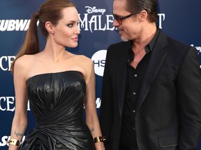 In this May 28, 2014 file photo, Angelina Jolie and Brad Pitt arrive at the world premiere of "Maleficent" in Los Angeles. Angelina Jolie Pitt and Brad Pitt have reached an agreement to handle their divorce in a private forum and will work together to reunify their family, the actors announced in a joint statement Monday, Jan. 9, 2017. (Photo by Matt Sayles/Invision/AP, File)