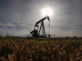 A pumpjack works at a well head on an oil and gas installation near Cremona, Alta., Saturday, Oct. 29, 2016. Jeff McIntosh/THE CANADIAN PRESS