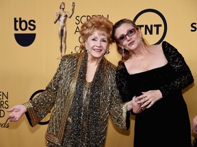 Actresses Debbie Reynolds (L), recipient of the Screen Actors Guild Life Achievement Award, and Carrie Fisher pose in the press room at the 21st Annual Screen Actors Guild Awards at The Shrine Auditorium on January 25, 2015 in Los Angeles, California. (Photo by Ethan Miller/Getty Images)
