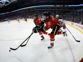 Calgary Flames centre Matt Stajan (18) and defenceman TJ Brodie (7) carry the puck past Winnipeg Jets right wing Chris Thorburn (22) during second period NHL hockey action in Winnipeg, Monday, January 9, 2017. THE CANADIAN PRESS/Trevor Hagan