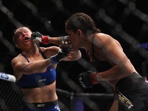 Amanda Nunes of Brazil punches Ronda Rousey in their UFC women's bantamweight championship bout during the UFC 207 event on December 30, 2016 in Las Vegas, Nevada. (Photo by Christian Petersen/Getty Images)