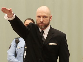 Anders Behring Breivik raises his right hand at the start of his appeal case in Borgarting Court of Appeal at Telemark prison in Skien, Norway, Tuesday, Jan. 10, 2017. (Lise Aaserud/NTB Scanpix via AP)