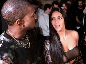 This file photo taken on September 29, 2016 in Paris shows (From L) Kanye West and Kim Kardashian attending the Off-white 2017 Spring/Summer ready-to-wear collection fashion show . 17 people were arrested over Kardashian Paris robbery according police source, AFP reported on January 9, 2017. Kardashian was tied up and robbed of jewellery worth around nine million euros ($9.5 million) when a gang of masked men burst into the luxury Paris residence where she was staying during Fashion Week in October. / AFP PHOTO / ALAIN JOCARD