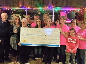 John Lawrence, left, the Chatham-Kent Hospice Foundation Board chair, receives a cheque from the ladies of “Pretty in Pink” with the Dover Ladies Group at their holiday party. The DLG raised $10,000 for the Chatham-Kent Hospice this year.
