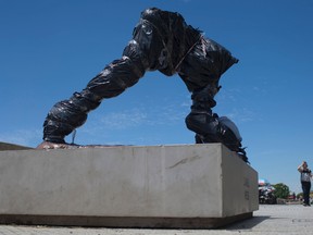 The severed statue of soccer star Lionel Messi is seen covered in Buenos Aires, Argentina, on Jan. 10, 2017. (AP Photo/Natacha Pisarenko)