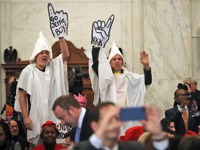 Protesters disrupted Sen. Jeff Sessions’ confirmation hearing for attorney general on Tuesday, including two men wearing Ku Klux Klan costumes and a woman wearing a pink crown.
