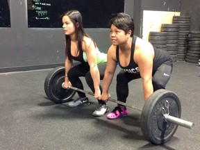 Catrina Earnshaw (left) and her mom Linda Rosario-Earnshaw team up to lift a heavy weight. (Martin Cleary, photo)