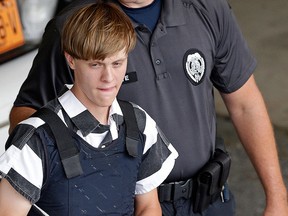 In this June 18, 2015 file photo, Dylann Roof is escorted from the Cleveland County Courthouse in Shelby, N.C.  (AP Photo/Chuck Burton, File)