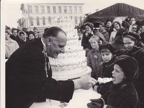 Former Kingston Mayor Robert Fray hands cake to then six-year-old Roy Sidders. Forget history and Canada’s Centennial, the press of the day recorded that Sidders quickly ate his piece of history. (Now 56 and a respected forester and Ontario Ministry of Natural Resources officer Sidders lives in Red Lake, Ontario.