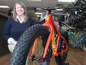 Beth Wartman, at Cyclepath Kingston shows a "fat bike" with its wider-than-normal tires designed for cycling in winter. Many cyclists continue to ride right through the winter. (Michael Lea/The Whig-Standard)