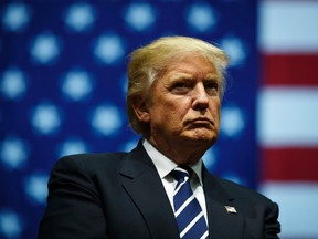 President-elect Donald Trump looks on during a rally at the DeltaPlex Arena, December 9, 2016 in Grand Rapids, Michigan. (Photo by Drew Angerer/Getty Images)