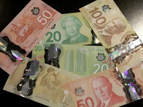 The new versions of the Canadian $20, $50 and $100 polymer notes are shown in Calgary, AB May 2, 2012.  JIM WELLS/CALGARY SUN/QMI AGENCY