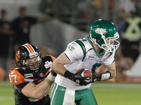 BC Lions Brent Johnson tackles Saskatchewan Roughrider quarterback Ryan Dinwiddle during the second half of CFL action at Empire Field in Vancouver, B.C., in this 2010 file photo. Johnson is one of five people being inducted into the Kingston and District Sports Hall of Fame. (CARMINE MARINELLI/Postmedia Network file photo)