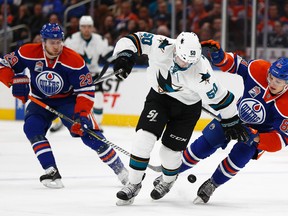 Edmonton Oilers' Matthew Benning and San Jose Sharks' Chris Tierney collide at Rogers Place in Edmonton on Tuesday, Jan. 10, 2017. (Ian Kucerak)