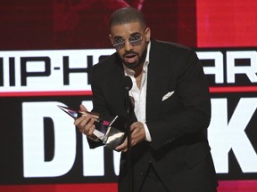 In this Nov. 20, 2016, file photo, Drake accepts the award for favorite artist - rap/hip-hop at the American Music Awards at the Microsoft Theater in Los Angeles. Drake is saluting President Barack Obama with a bizarre image of the Canadian rapper’s face mixed with the president’s. He shared the picture on Instagram Jan. 10, 2017, following Obama's farewell speech. (AP/FILE)