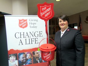 Capt. Nancy Braye is shown in this file photo standing next to an iconic red kettles at the Salvation Army in Sarnia, Ont. The recent Sarnia and Corunna kettle campaign raised more than $132,000. (Paul Morden/Sarnia Observer)