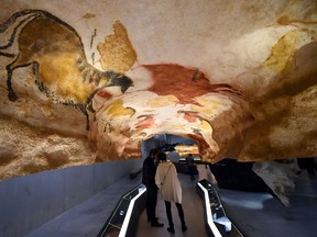 People visit the new replica of the Lascaux cave paintings during the first public opening on December 15, 2016 in Montignac, in the Dordogne region of southwest France, more than seven decades after the prehistoric art was first discovered. / AFP / MEHDI FEDOUACH (Photo credit should read MEHDI FEDOUACH/AFP/Getty Images)
