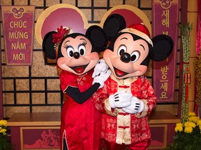 This January 2016 image provided by Disneyland Resort shows Mickey Mouse and Minnie Mouse dressed in red for a Lunar New Year celebration at Disney California Adventure Park in Anaheim, Calif. The park will celebrate year of the rooster this year from Jan. 20 through Feb. 5 with live performances, activities, decor, special food and Disney characters dressed for the Lunar New Year holiday. (Disneyland Resort via AP)