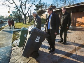Toronto Mayor John Tory walks out of a garage with a waste bin on Markland Drive, near Bloor St. W., west of the 427, in Toronto, on Wednesday January 11, 2017. Tory talked about the future of curb side waste collection east of Yonge Street. (ERNEST DOROSZUK/TORONTO SUN)