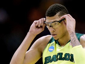 In this March 21, 2014 file photo, Baylor's Isaiah Austin adjusts his glasses during a second-round game against Nebraska in the NCAA college basketball tournament, in San Antonio. (AP Photo/Eric Gay, file)