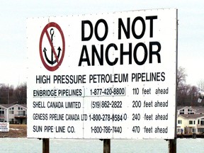 A sign near Corunna, south of Sarnia, Ont., marks where several pipelines cross the St. Clair River between Michigan to Ontario. A First Nation band in northern Wisconsin has called on Enbridge to remove a section of its Line 5 pipeline that crosses the reserve. The pipeline carrying oil and natural gas liquids runs between Superior, Wisconsin and Sarnia. (File photo/Sarnia Observer/Postmedia Network)