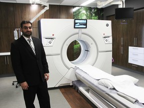 Dr. Youssef Almalki poses with Bluewater Health's $2.1-million CT scanner. The state-of-the-art machine has been incorporated into a room designed to help patients feel more at ease. (Tyler Kula/Sarnia Observer file photo)
