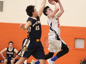 Anthony Rogerson of College Notre Dame  tries to block a shot by Nick Burke of the Lasalle Lancers during junior boys basketball action in Sudbury, Ont. on Tuesday January 10, 2017. Gino Donato/Sudbury Star/Postmedia Network