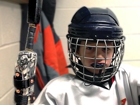 Connor Young, 7, can play hockey thanks to a new device that accounts for a hand disability.