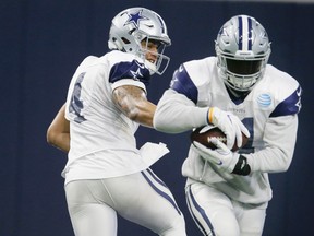 Cowboys running back Ezekiel Elliott (right) takes the handoff from quarterback Dak Prescott during an indoor practice at the team's headquarters in Frisco, Texas, on Wednesday, Jan. 11, 2017. (LM Otero/AP Photo)