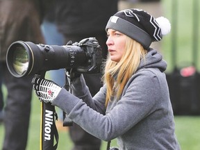 Photographer Johany Jutras surveys the action on the field while she shoots an Ottawa Redblacks game for her book. (Chris Hofley photo)
