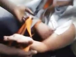 This image from a video that was broadcast live on Facebook and later posted on Vidme shows a frame in which a man, right, is assaulted in Chicago. The video shows the man with his mouth taped shut as a woman and other people cut off his shirt and hair with a knife, and someone pushes his head with his or her foot. Chicago Police Supt. Eddie Johnson said Wednesday, Jan. 4, 2017, that the victim has mental health challenges, and he called the video "sickening." (Vidme via AP)