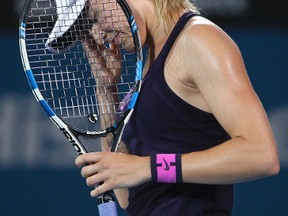 Eugenie Bouchard lowers her head after missing a shot to Johanna Konta during their women's semifinal singles match at the Sydney International on Jan. 12, 2017. (AP Photo/Rick Rycroft)