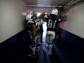 Members of the San Diego Chargers touch hands in the tunnel prior to a game against the Kansas City Chiefs at Qualcomm Stadium on Jan. 1, 2017. (Sean M. Haffey/Getty Images)