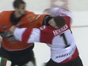 Adam Vay, orange, punches Michael Houser during a fight in the ECHL (YouTube screen grab)