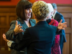 Marie-France Lalonde is all smiles as she is welcomed by Ontario premier Kathleen Wynne during a swearing-in ceremony at Queen's Park in Toronto on Thursday, Jan. 11, 2017. Lalonde has been moved to the corrections ministry in a mini-cabinet shuffle. (ERNEST DOROSZUK/TORONTO SUN)