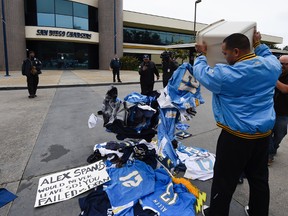 A former Chargers fan dumps memorabilia in front of of the San Diego Chargers headquarters after the team announced that it will move to Los Angeles on Jan. 12, 2017. (AP Photo/Denis Poroy)