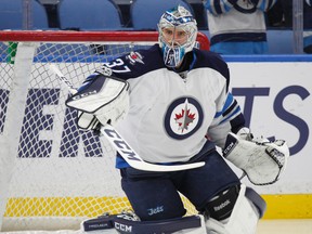 Goaltender Connor Hellebuyck is one of three restricted free agents still to be resigned by the Jets, who had their projected salary cap hit bumped to over $64 million following its free agent deals on July 1, 2017. (AP File Photo/Jeffrey T. Barnes)
