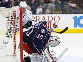 Columbus Blue Jackets' Curtis McElhinney covers the puck after saving a shot against Los Angeles Kings during an NHL game on Dec. 20, 2016. (AP Photo/Jay LaPrete)