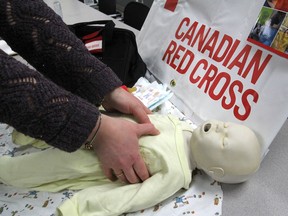 Instructor/trainer Tanya Hamilton, at the Red Cross office in Kingston on Wednesday, demonstrates one of the first aid techniques taught during the Red Cross babysitting course. (Michael Lea/The Whig-Standard)