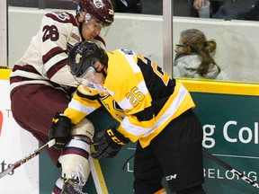 Kingston Frontenacs’ Ted Nichol, right, collides with the Petes' Josh Coyle along the boards during OHL action Nov. 3, 2016, at the Memorial Centre in Peterborough. (Clifford Skarstedt/Postmedia Network)