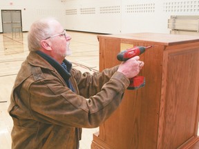 Don Humphreys seals the wooden cabinet he made and donated to the Lomond Time Capsule project. The cabinet holds several boxes and envelops submitted by the community, Lomond Community School students and staff. It was sealed at the school on Monday, Jan. 9. Jasmine O'Halloran Vulcan Advocate