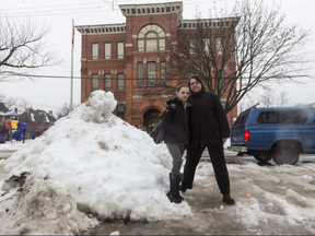 Stephanie ter Veen and her daughter Francesca along First Avenue in Ottawa where large snow banks and ice and water buildup has made it difficult for parents and students to get to First Avenue Public School. Thursday January 12, 2017. (Errol McGihon, Postmedia)