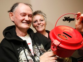 Luke Hendry/The Intelligencer
Salvation Army volunteer and client Barry Gay holds a donation kettle with campaign co-ordinator Debbie Scott at Pinnacle Street office Thursday in Belleville. This year's campaign raised more than $178,000, about 11 per cent more than its goal.