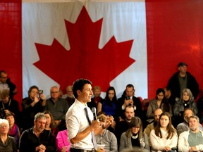 With the Maple Leaf in the background, Prime Minister Justin Trudeau speaks during a town hall meeting attended by approximately 265 people in Memorial Hall at City Hall on Thursday. (Ian MacAlpine/The Whig-Standard)