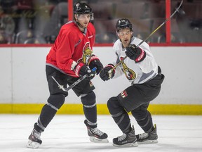 Bobby Ryan (left) and Clarke MacArthur look for the puck during the Senators’ practice yesterday at the Canadian Tire Centre. (WAYNE CUDDINGTON/Postmedia Network)