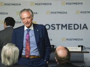 Postmedia CEO Paul Godfrey speaks with people during the company's annual general meeting in Toronto on Jan. 12, 2017. (THE CANADIAN PRESS)