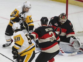 Senators goalie Mike Condon makes a save against Pittsburgh Penguins’ Chris Kunitz during last night’s game at the CTC. (TONY CALDWELL/Ottawa Sun)
