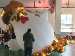 A giant inflatable rooster widely perceived in China to resemble U.S. president-elect Donald Trump is inflated at a factory in Jiaxing near Shanghai, Friday, Jan. 13, 2017. The factory Yifang Inflatables began selling the inflatables after images of a large sculpture of a similar design outside a shopping centre in the northern city of Taiyuan went viral on social media last month. (AP Photo/Paul Traynor)